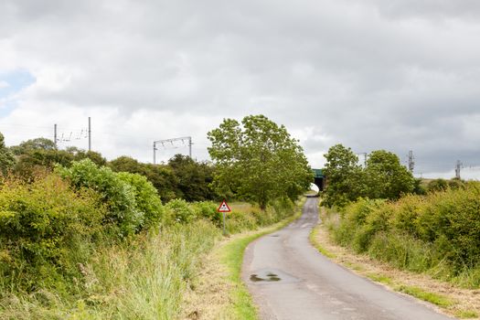 The view along a country lane in Clifton northern England towards the west coast main line.