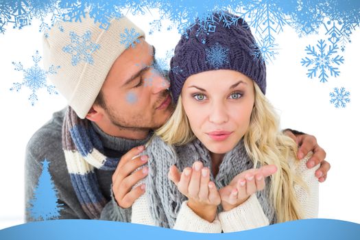 Attractive couple in winter fashion against snow flake frame in blue