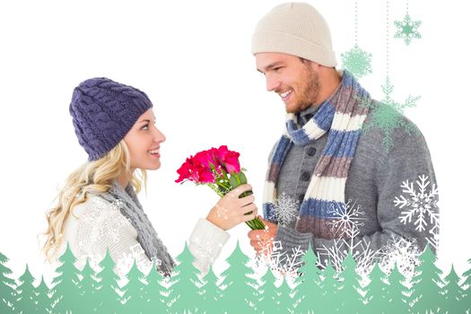 Attractive man in winter fashion offering roses to girlfriend against snowflakes and fir trees in green