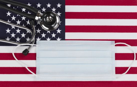 Medical stethoscope and protective mask with United States flag as background 