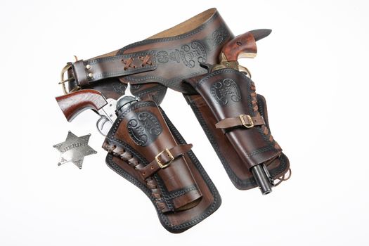 Leather cowboy holster and revolver on an isolated studio background