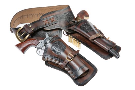 Leather cowboy holster and revolver on an isolated studio background