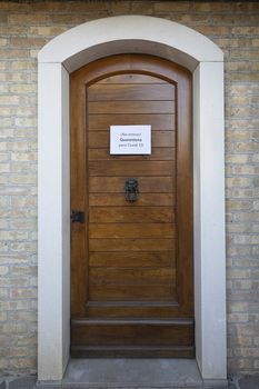 The sign Quarantine  for Covid-19 virus in spanish language on a wooden entrance door