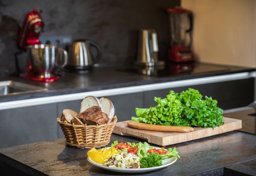 Omelet with herbs and vegetables on a gray table in the kitchen