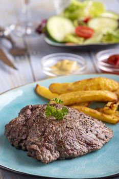 steak on a plate with french fries