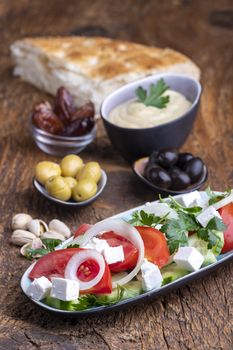 olives and hummus on dark wood