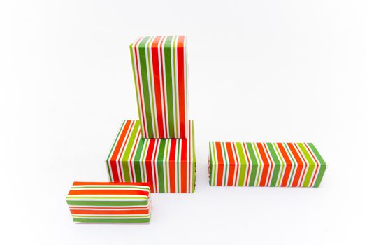 Boxes with xmas presents wrapped. Multi colored purchases. Isolated on white background