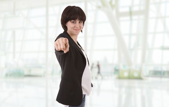 young happy beautiful business woman pointing, at the office