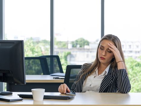 Morning work atmosphere In a modern office. Teen employees rest her eyes due to dizziness and headaches. After clearing the remaining pending work.