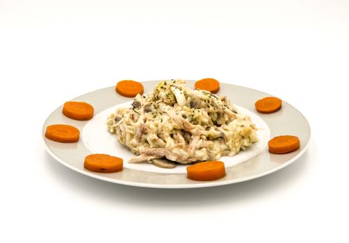 Plate of chicken hen with carrot slices on a white background