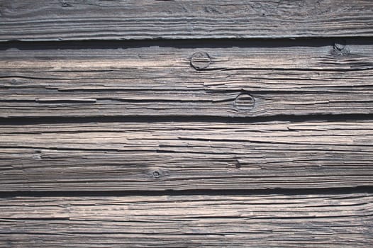 The picture shows a background with grey wooden boards