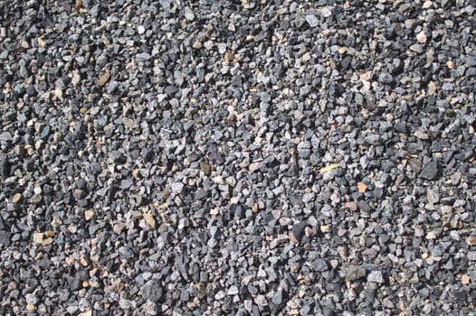 The picture shows a background with little grey stones