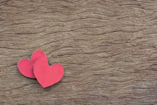 Valentines Day background with red heart shape on dark wooden background with copy space
