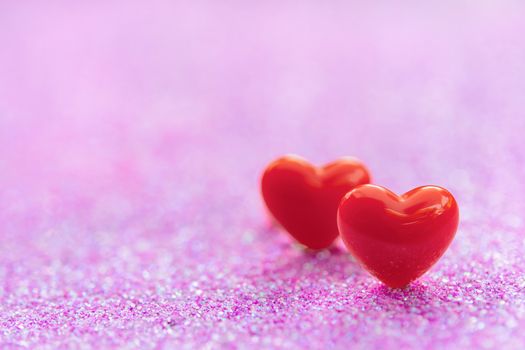 Valentines Day background with Red heart shapes on abstract light pink glitter background, Copy space