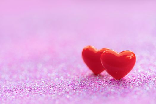 Valentines Day background with Red heart shapes on abstract light pink glitter background, Copy space