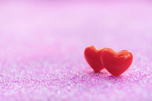 Valentines Day background with Red heart shapes on abstract light pink glitter background, Copy space