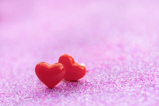 Valentines Day background with Red heart shapes on abstract light pink glitter background, Copy space
