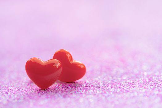 Valentines Day background with Red heart shapes on abstract light pink glitter background, Copy space