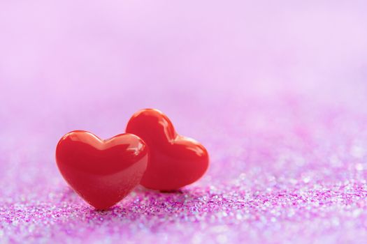 Valentines Day background with Red heart shapes on abstract light pink glitter background, Copy space