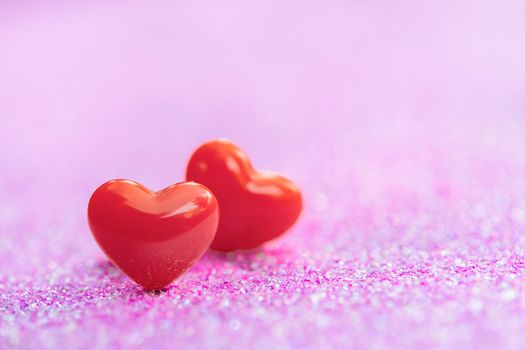 Valentines Day background with Red heart shapes on abstract light pink glitter background, Copy space