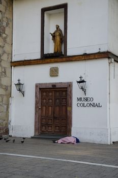 Colonial Museum and vagrant sleeping on the floor. Fray Pedro de Bardeci square. Santiago de Chile. Chile.