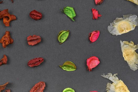 Dry aromatic potpourri leaves close-up. Background of colored aromatic potpourri leaves. Geometric pattern - raws