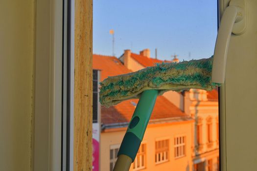 Cleaning windows with a squeegee. Cleaning concept. Washing window, close up. Looking through window