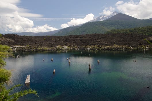 Arco Iris lagoon and Llaima volcano covered by clouds. Conguillio National Park. Araucania Region. Chile.