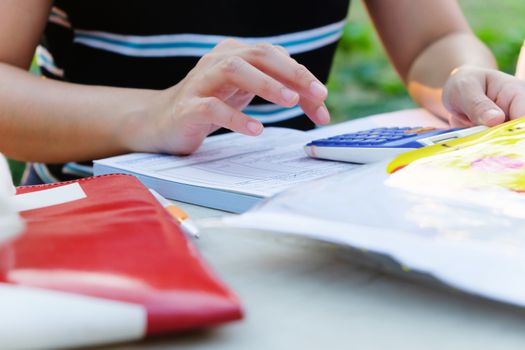 Close up female hands of accountant with calculator and pen. business accounting background.
