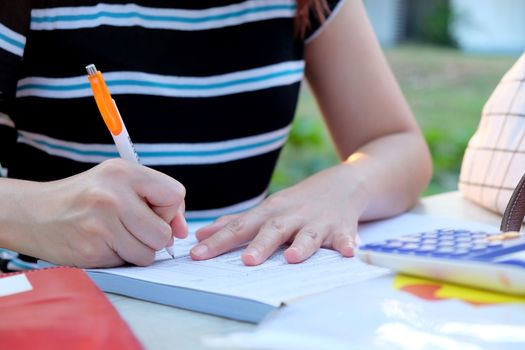 Close up female hands of accountant with calculator and pen. business accounting background.