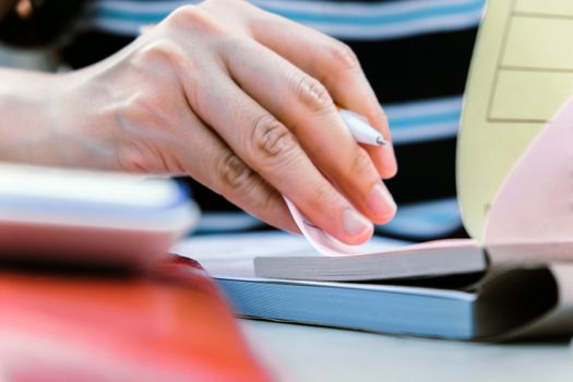 Close up female hands of accountant with calculator and pen. business accounting background.