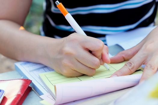 Close up female hands of accountant with calculator and pen. business accounting background.