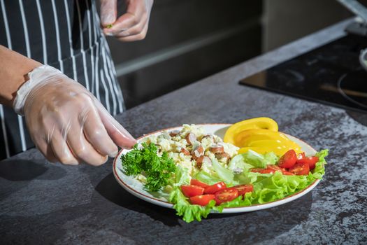 Omelet with herbs and vegetables on a gray table in the kitchen