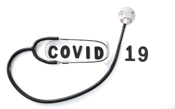 Covid 19 virus conceptual image with text in black om white and stethoscope