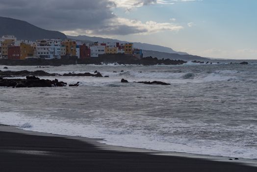 Sunset view to cape Punta Brava from Famous beach Playa Jardin with black sand in Puerto de la Cruz, Tenerife, Spain