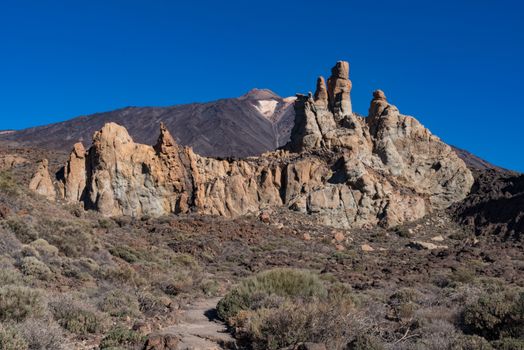 View of Roques de García unique rock formation with famous Pico del Teide mountain volcano summit in the background on a sunrise, Teide National Park, Tenerife, Canary Islands, Spain