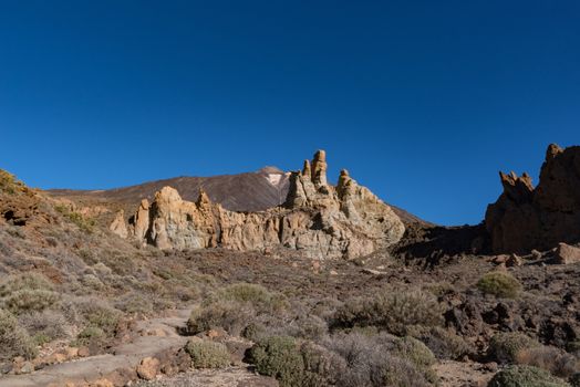 View of Roques de García unique rock formation with famous Pico del Teide mountain volcano summit in the background on a sunrise, Teide National Park, Tenerife, Canary Islands, Spain