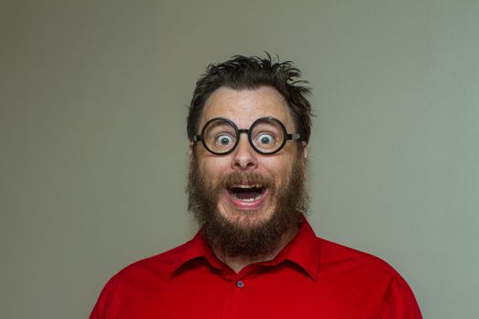 Man wearing a dress shirt with messy hair making a huge smile face