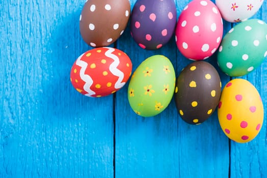Easter eggs top view on blue wooden background and have copy space for use