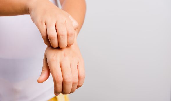 Asian beautiful woman itching her useing hand scratch itch hand on white background with copy space, Medical and Healthcare concept