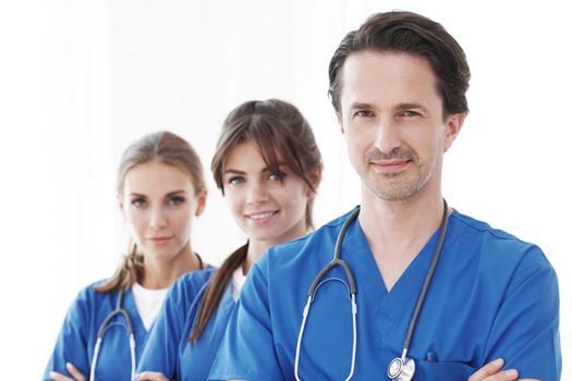 Portrait of group of smiling hospital colleagues standing together isolated on white background