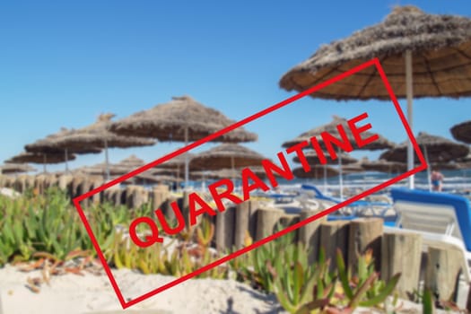 Text of the quarantine against the background of an empty sandy beach in Tunisia. The concept of the collapse of the tourism industry. The sea coast is closed to tourists for quarantine