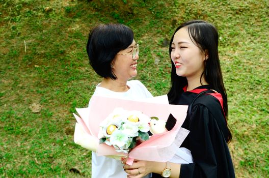 Asian university student and mother celebrating graduation