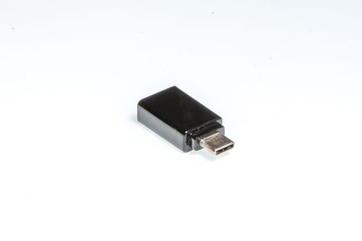 detail of a black usb-c adapter on a white background