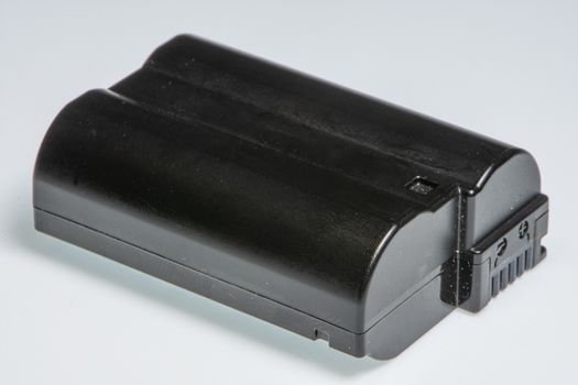 Detail of a camera battery, on a white background