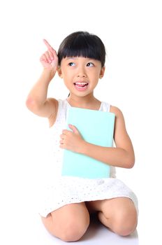 Cute little girl holding book with index finger up, Isolated over white