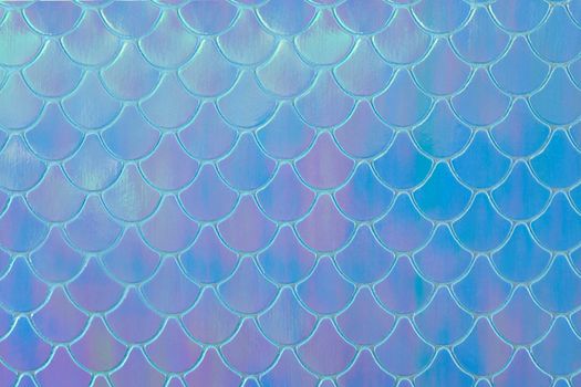Abstract textured holographic background from leather surface, like mermaid or fish scales. Trendy multicolor texture with copy space. Celebration, holidays, fashion concept. Horizontal.
