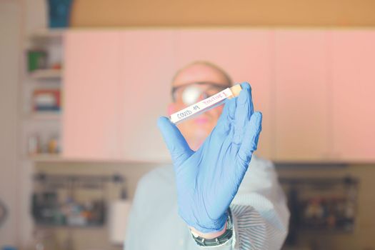 Doctor holds COVID 19 Coronavirus vaccine in his hand, infected sample in the sample tube, Vaccine and syringe injection It use for prevention, immunization and treatment from COVID-19