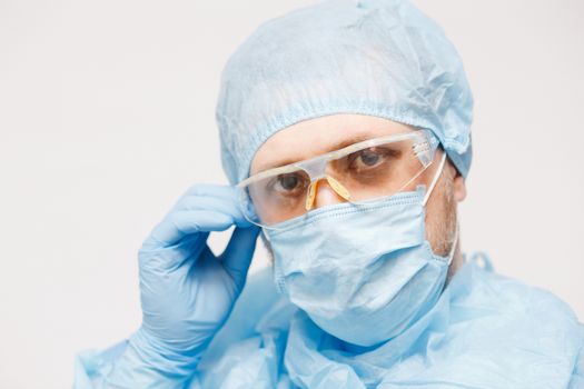 Close up of doctor with mask. Medical equipment. A doctor wearing personal protective equipment including mask, goggle, and suit to protect COVID 19 coronavirus infection.