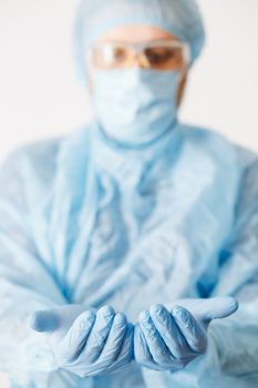 Close up of doctor hand holding. Mock up. Medical equipment. A doctor wearing personal protective equipment including mask, goggle, and suit to protect COVID 19 coronavirus infection.